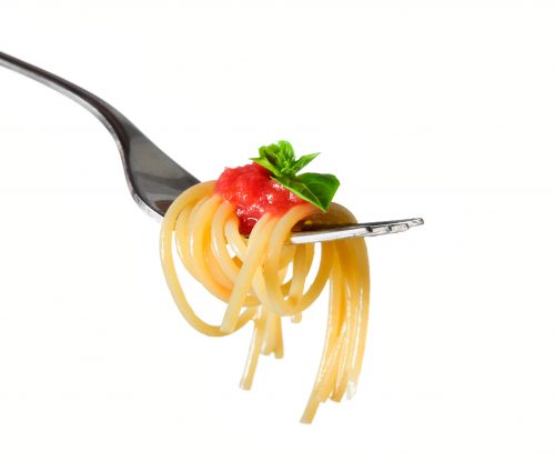 Spaghetti pasta with tomato and basil on fork isolated on white